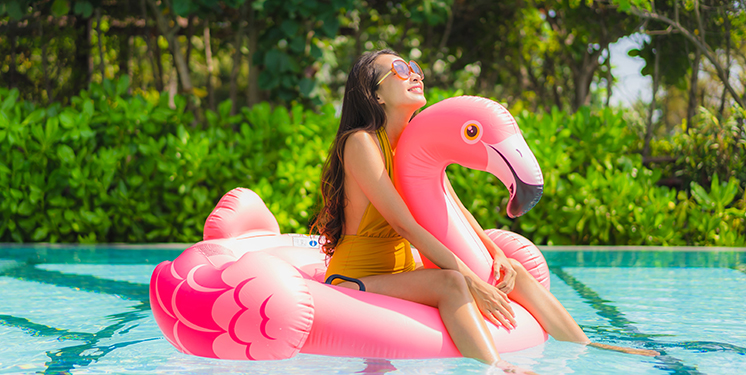 young-woman-on-flamingo-pool-floatie-746x375